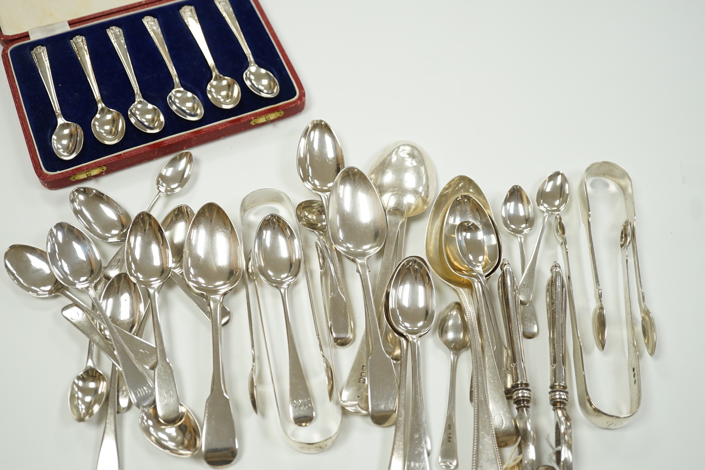 A quantity of assorted mainly 19th century silver flatware, various patterns, dates and makers, including a cased set of six 1937 Coronation silver teaspoons, four pairs of Georgian sugar tongs and a pair of Edwardian si